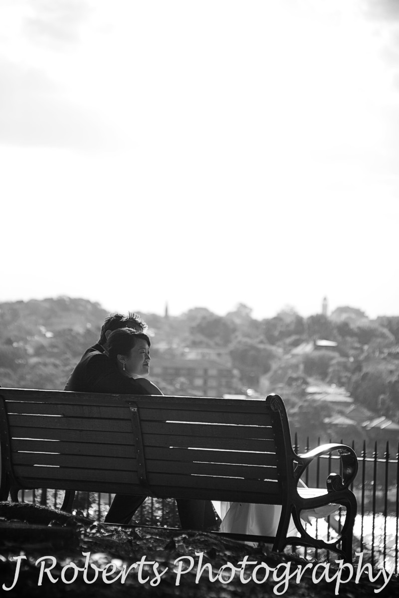 Couple enjoying the view from park bench observatory hill - wedding photography sydney